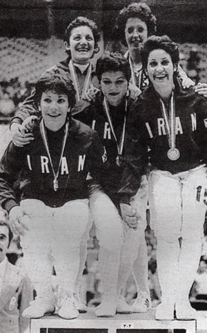 Photo: The 1974 Iranian women's fencing team, winners of the gold medal at the 1974 Asian Games. To date, this is the only gold medal Iranian women athletes have won in international competition. Prior to the Iranian Revolution in 1979, female sports centres and teams had begun to be established throughout the country. The Taj Recreation Centre became the first club to train women. As Batool Bagheri, one of the first Iranian football players, described it " in 1970, after a long struggle, we found a place where we could hold our practices. Before that, we sometimes played without husbands and brothers in the alleyways, but in 1970 we gained official permission to, without men, practice on a real field. " When the new Islamist government took hold in 1979, women's sporting competitions were disbanded for several years. When they were reinstated in 1981, veiling of all female athletes was made mandatory and gender segregation rules meant that women coaches, referees and managers would need to be trained before women's sporting events could be reinstated. It would not be until 1990 that Iranian women would compete internationally again. 