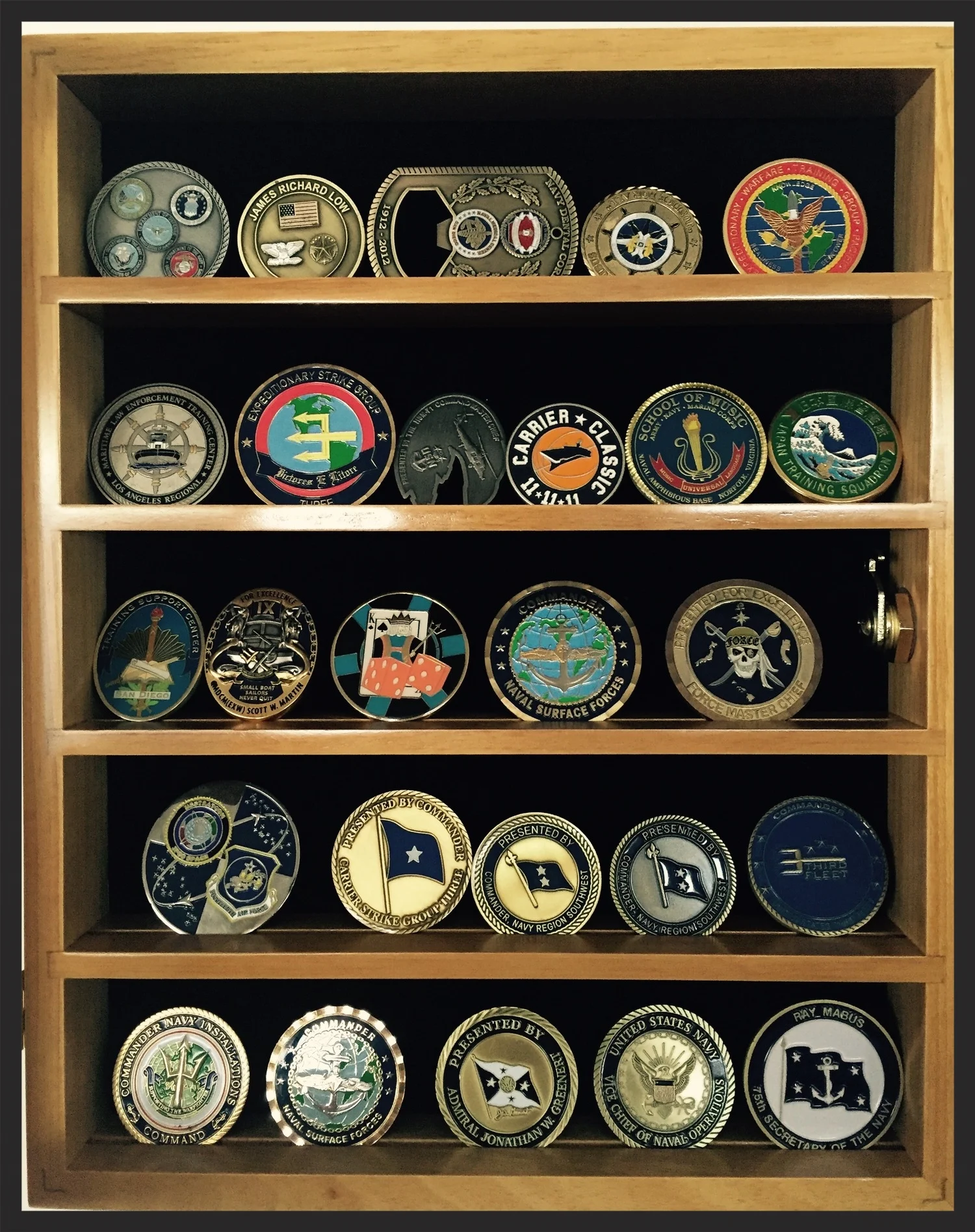 26 challenge coins, proudly displayed at my home in San Diego, CA.