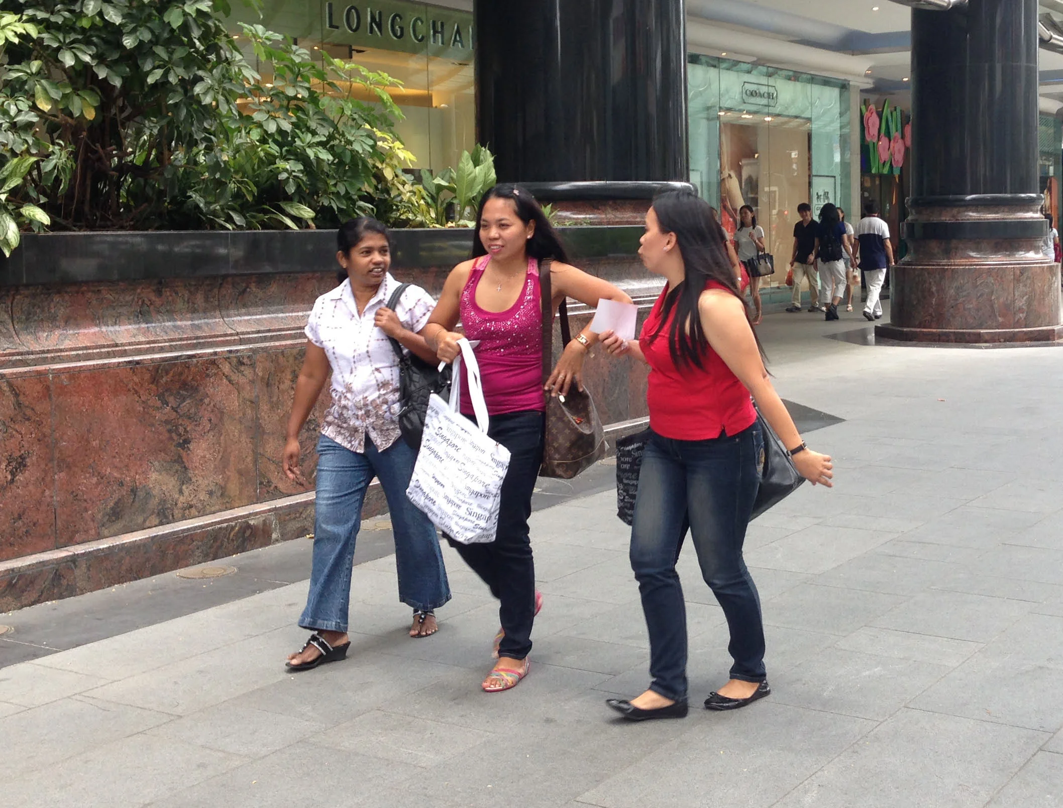 On Sundays the domestic helpers meet their friends on Orchard Road.