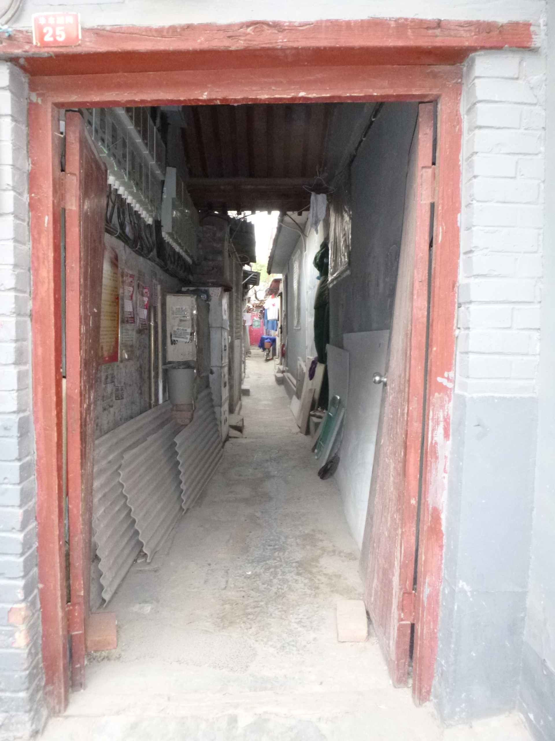 A doorway in the hutong. See all the stuff stored at the side? This can be dangerous when someone's trying to navigate their way home at night. 