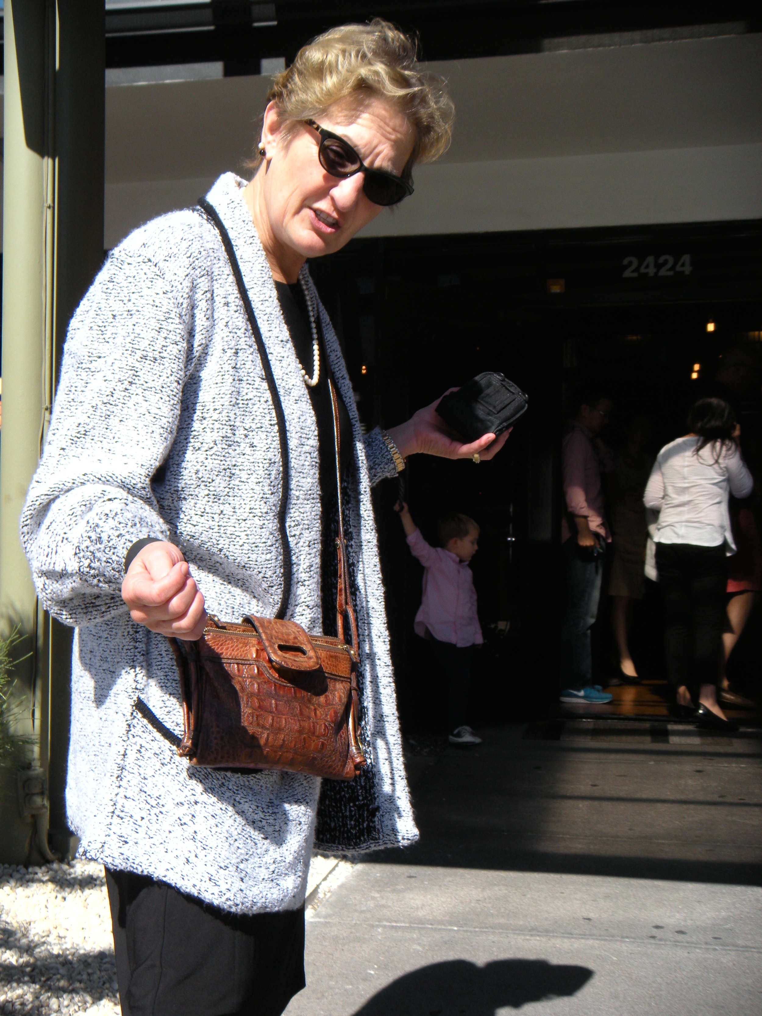 I'm scowling at David, telling him to get a move on, quit taking my picture--we're running late. That purse is looking worn, but don't worry, I selected another for David to get me for Christmas, same brand, similar in style, only red. Brahmin. Beautiful. 