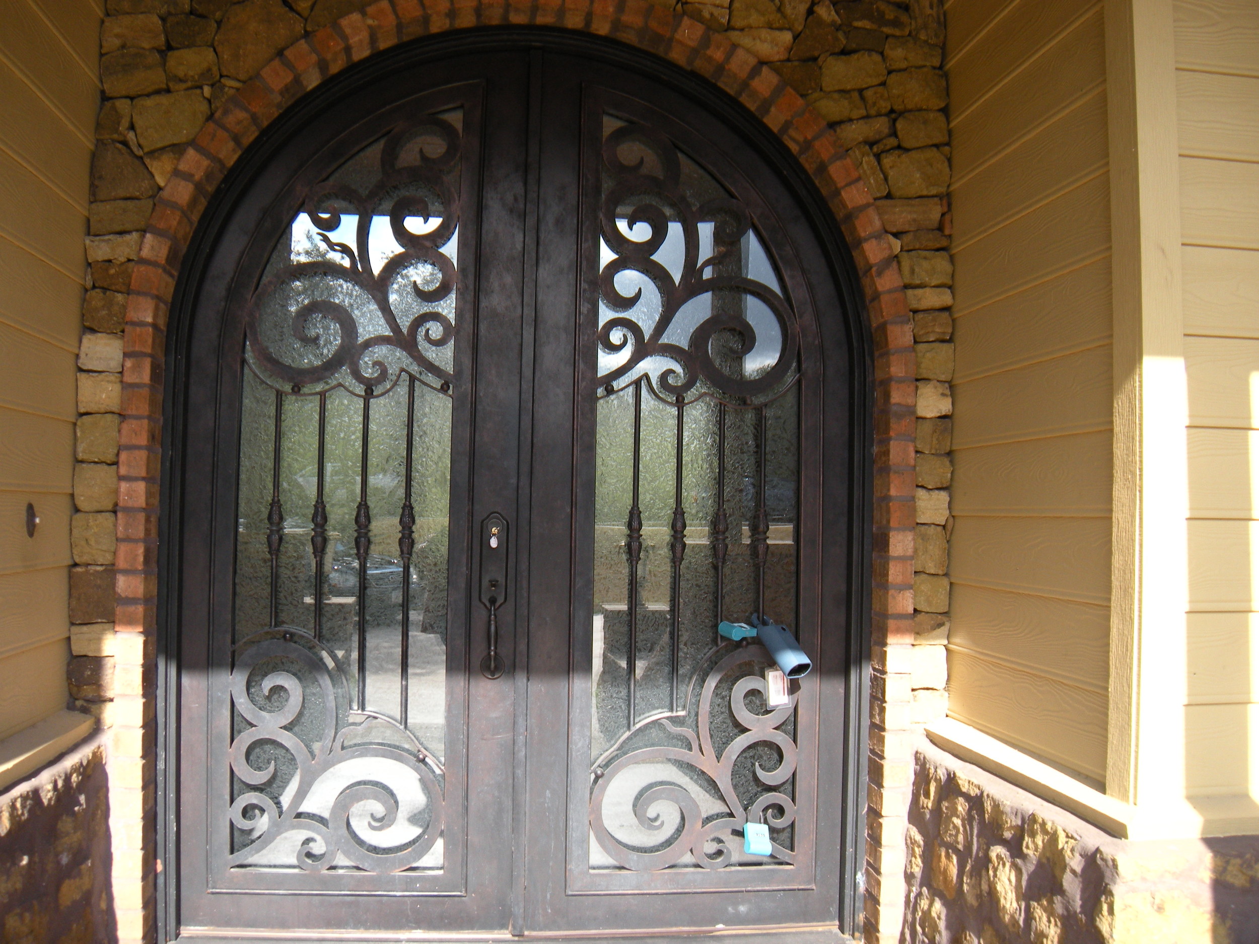 Isn't this a beautiful front door? You can't tell by looking, but that's wrought iron, not wood. 