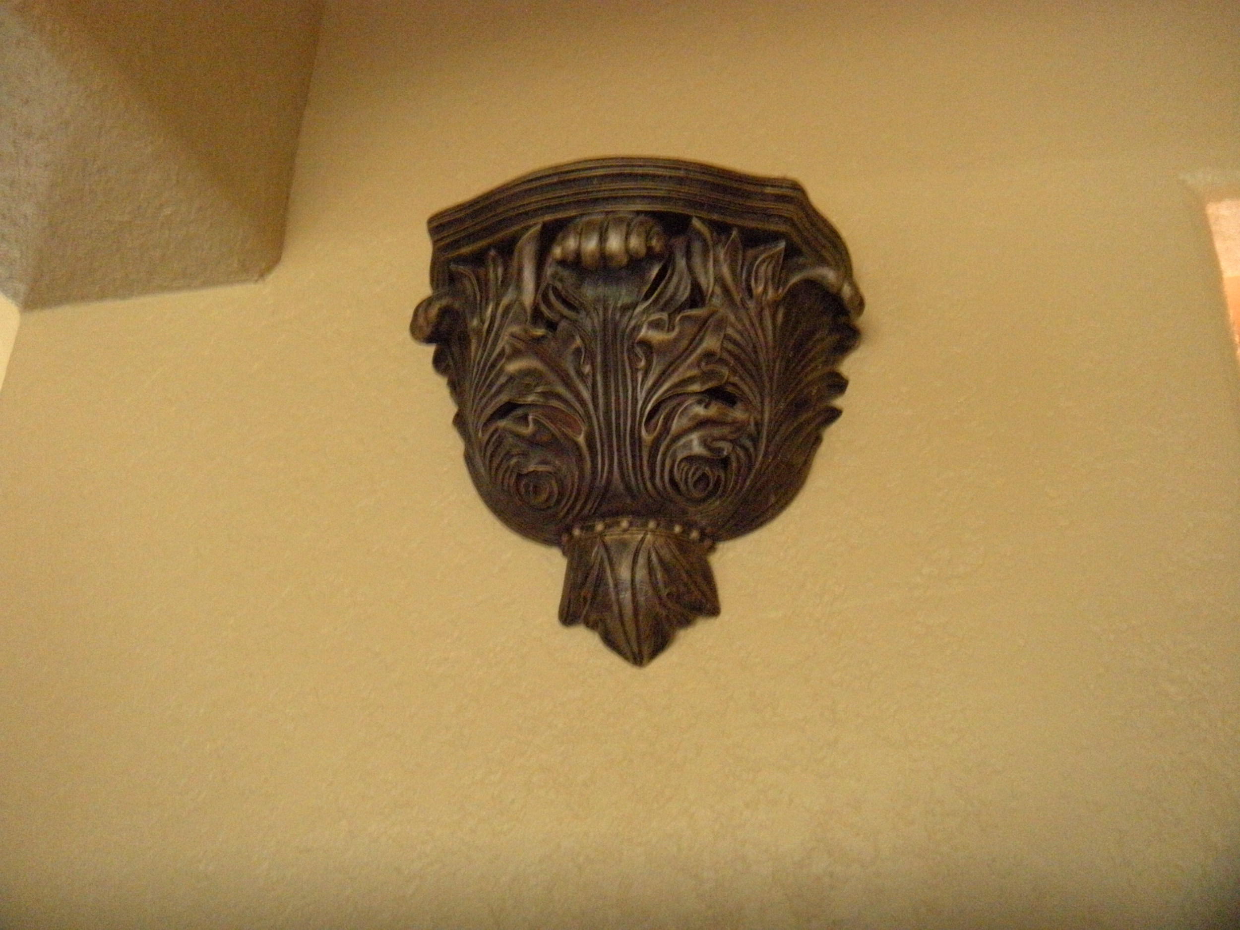 What's the point of this fixture? Do we set a candle or plant on it? It's set really high on the wall. 