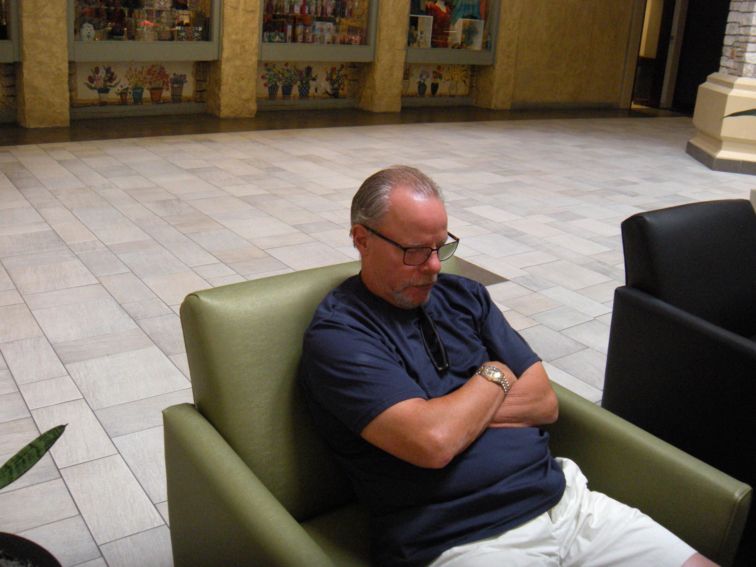 This is what David does while I shop. The way his arms are resting on his belly makes him look fat, but he's actually lost fifteen pounds now that he's not sitting at a desk all day and he's so active outdoors. 