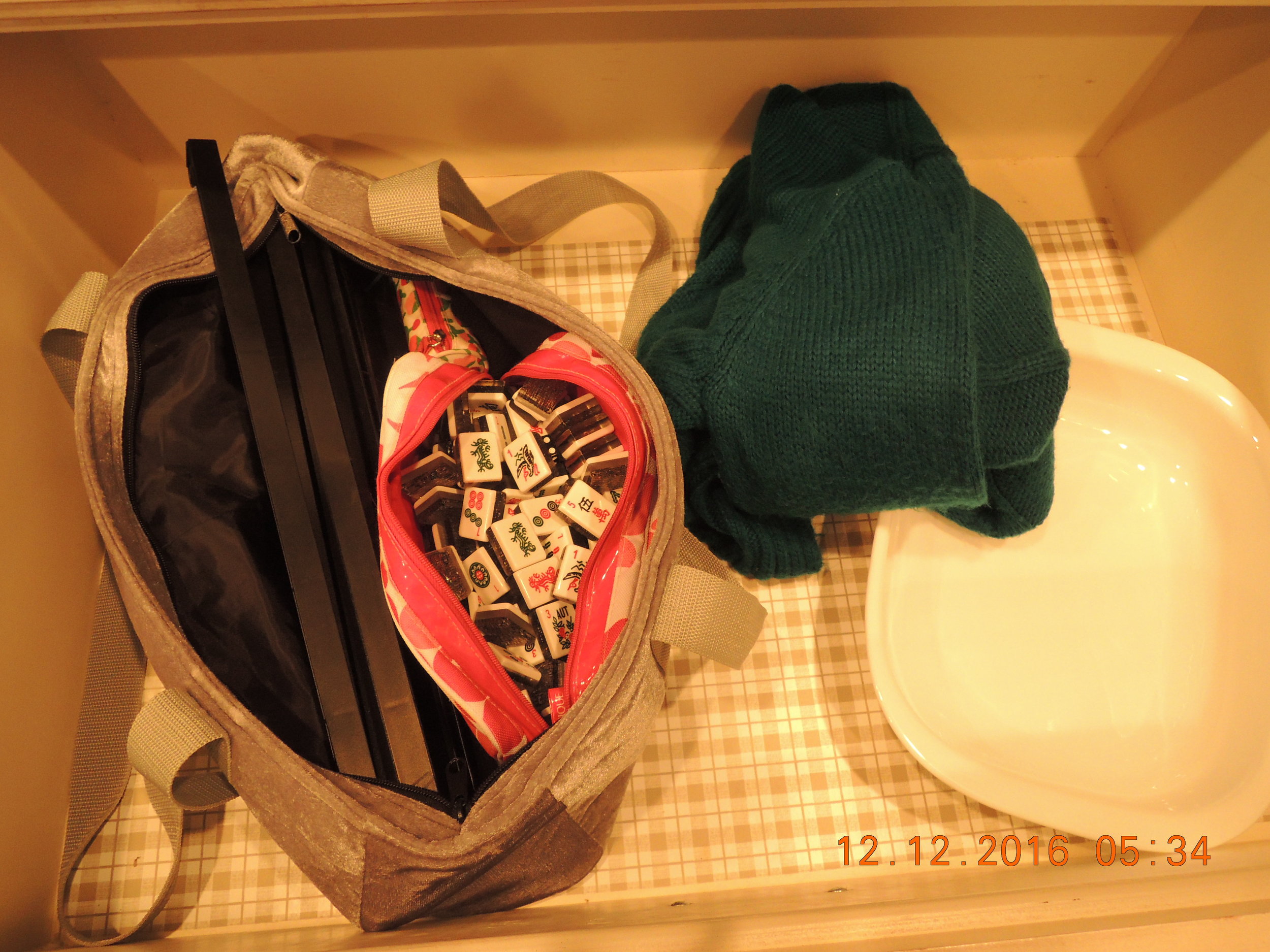 A Mahjong set, a sweater, a nice baking pan. The hostage drawer. 
