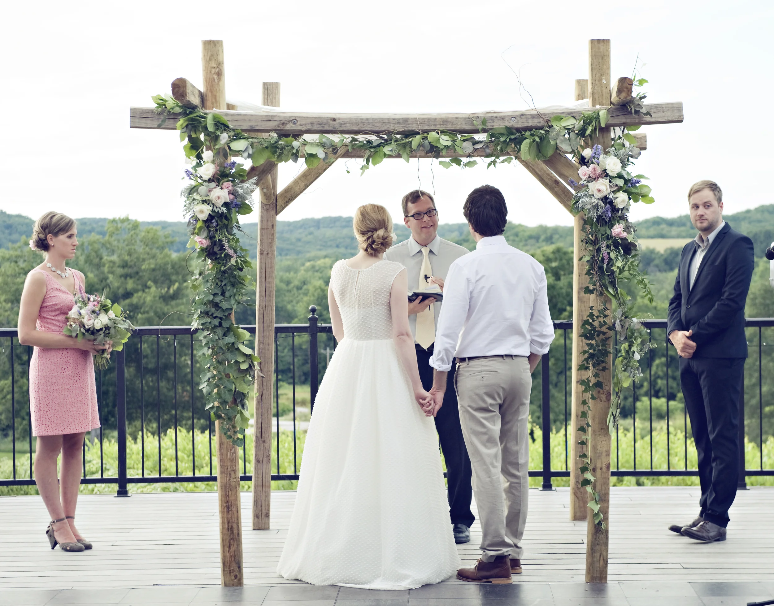 A homemade, rustic chuppa, decorated with flowing swags and garlands at Chandler Hill Winery.