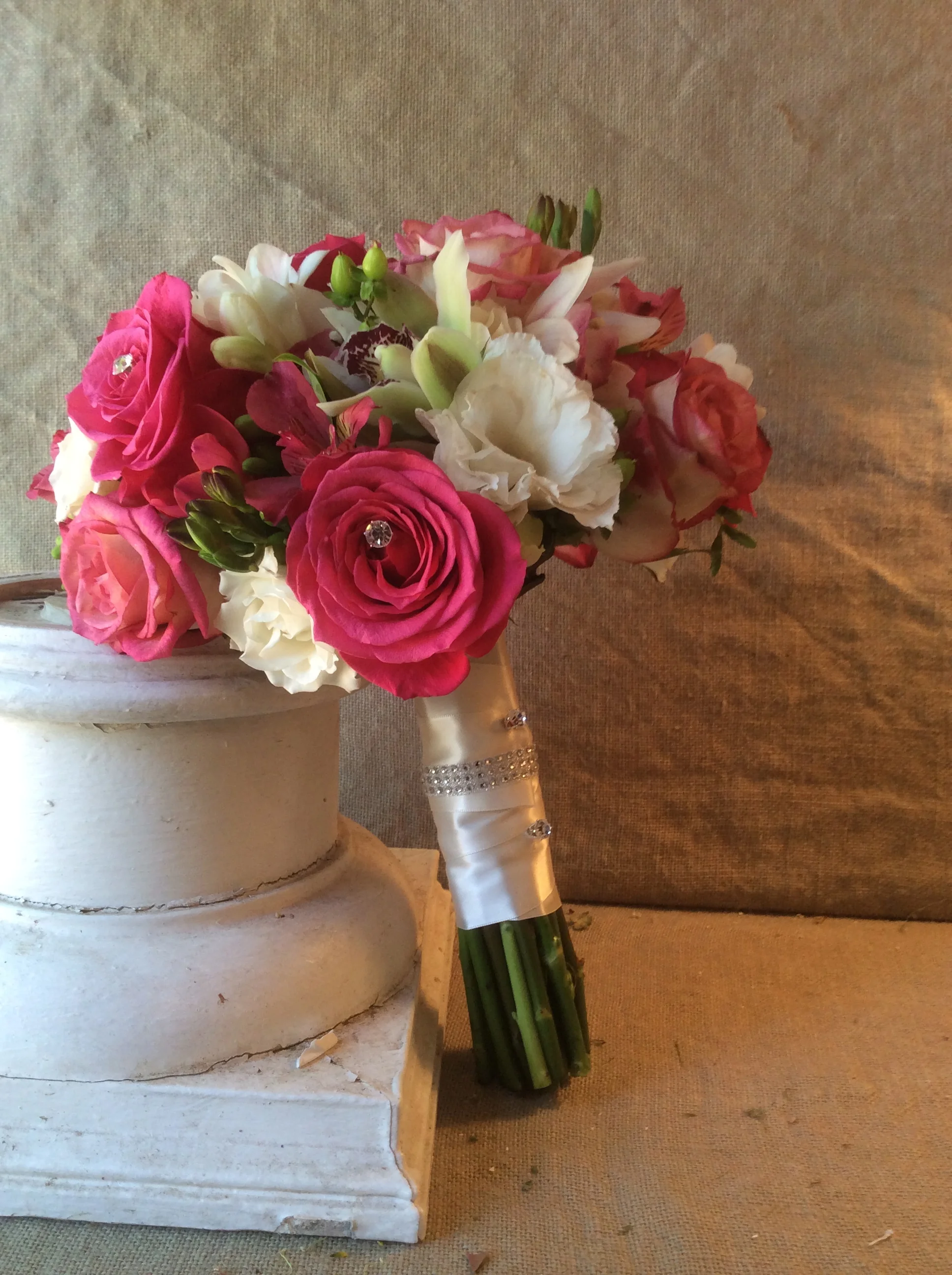 Roses, orchids and freesia get a little glam with the addition of rhinestones and a bejeweled wrap.