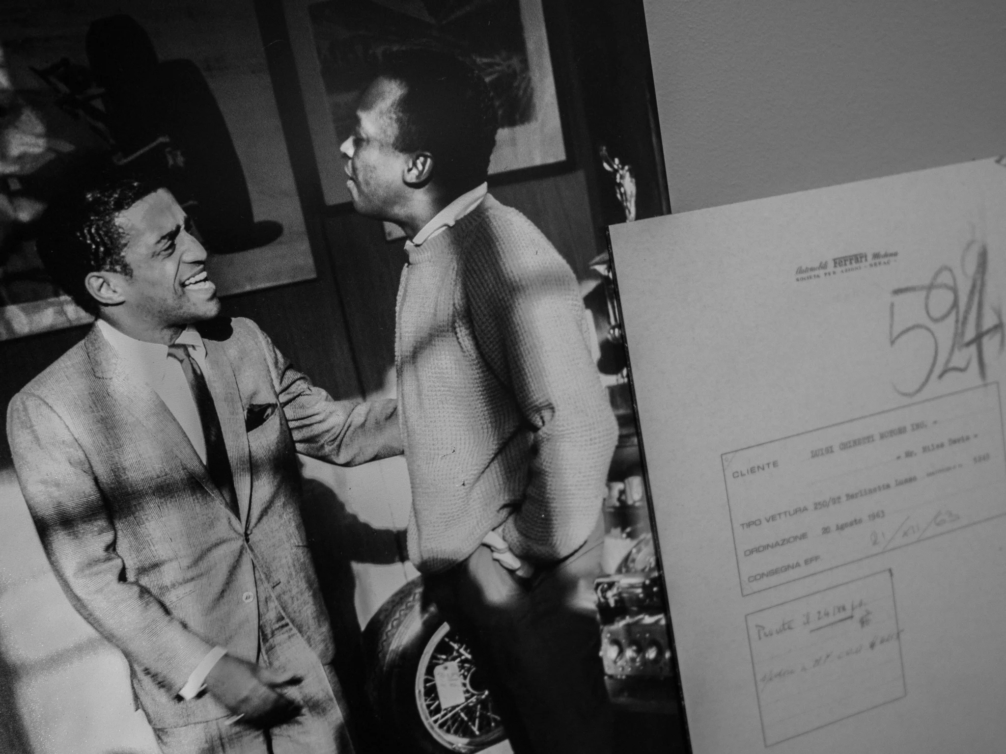 Sammy Davis Jr and Miles Davis were both Ferrari owners, pictured here at a Ferrari dealership with an order form for one of their cars