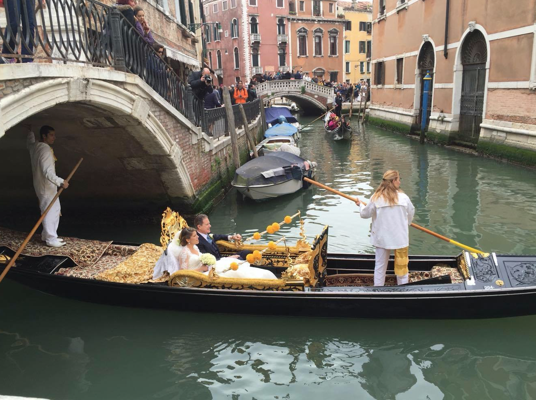 This beautiful bride is getting married in Venice, Italy. The bride and her father are doing the traditional Gondola ride through the canals of Venice to the church. All of the guests are standing on the bridge and above her to welcome the bride and her father to the church. Some traditional brides in Italy, however, will replace the "something blue" with a green dress or accessory. 