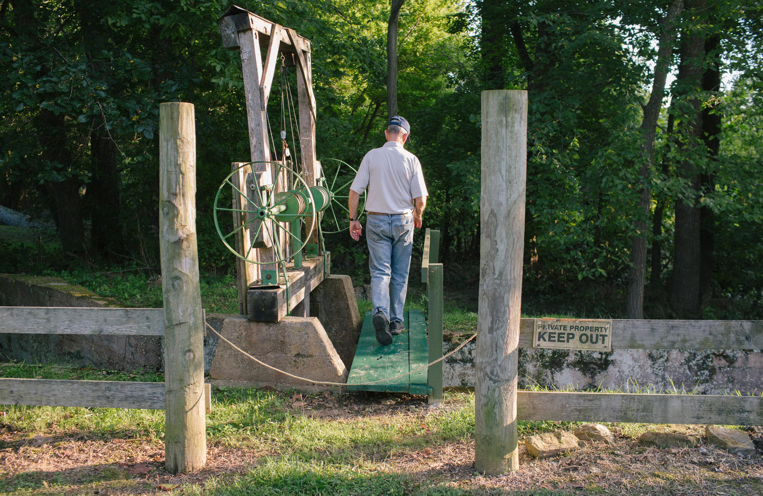 Clyde Beal walks across an unused water channel built for a previous incarnation of Britain Mill at Turnback Creek near Halltown, Mo. on Aug. 13, 2015. There are three different water channels for the three mills that have been built at the site. Photos by Brad Zweerink
