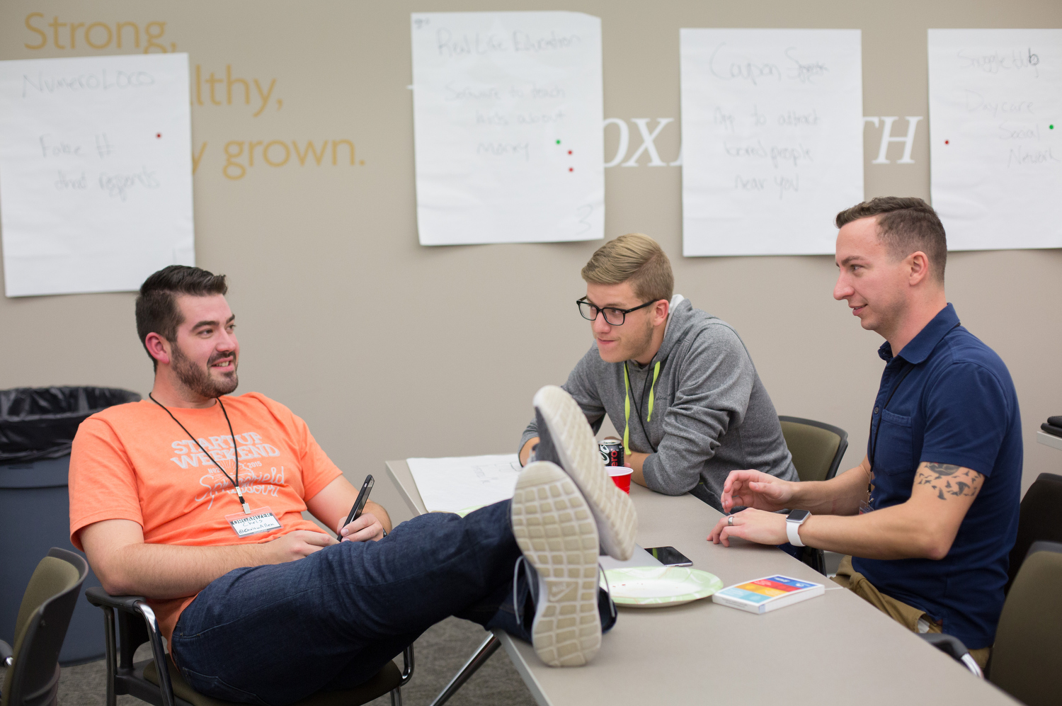Chris Allen, left, a Startup Weekend Springfield organizer, talks with Tim Cook and Dan Seawel, right, during the competition at the eFactory in Springfield, Mo. on Nov. 20, 2015. Photos by Brad Zweerink