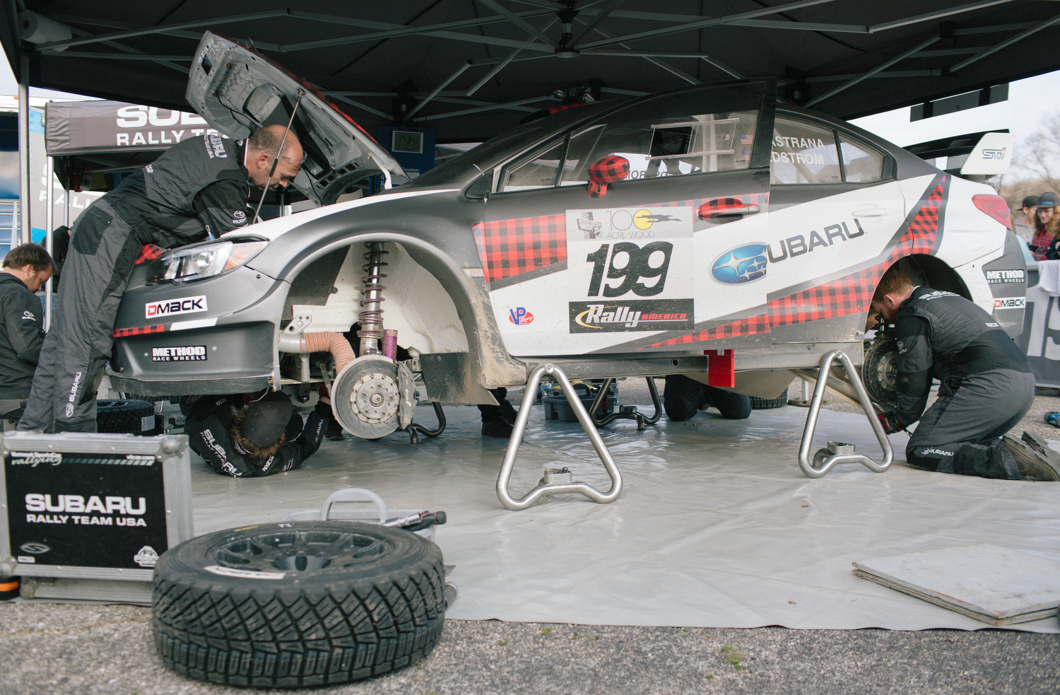 Subaru Rally Team USA crew members work on Travis Pastrana's 2016 Subaru WRX STI.
