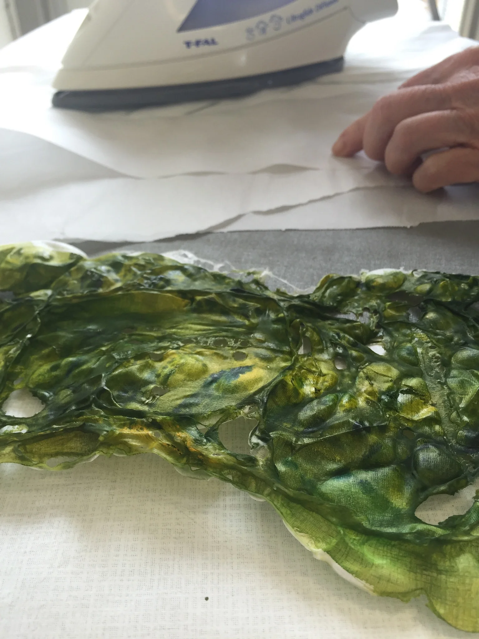 Student creating tyvek collage materials.