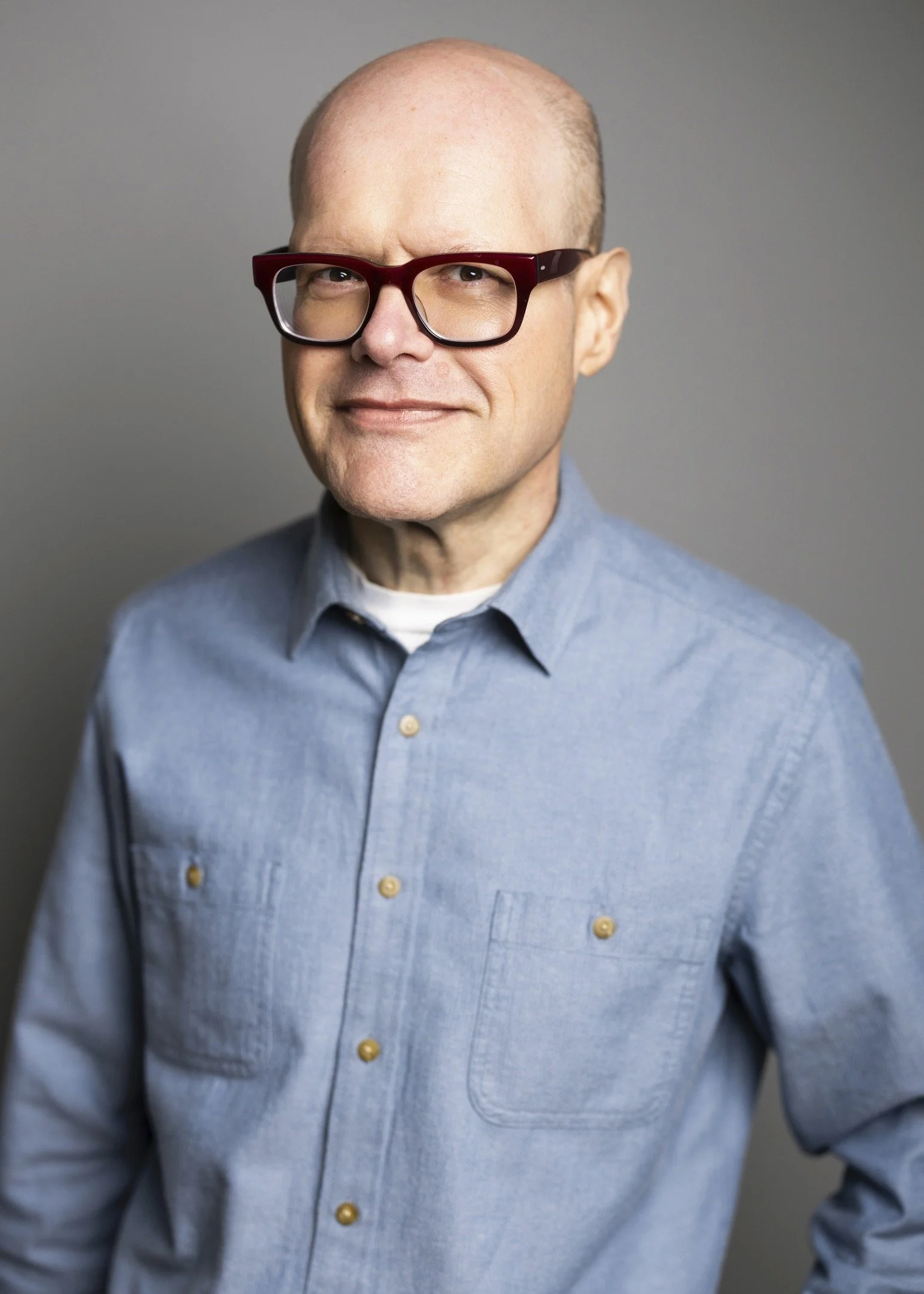 Image of Michael Dryja, USPTO Registered patent attorney. He is a caucasian, middle-aged man with reddish-brown heavy framed glasses and a chambray colored button down shirt.