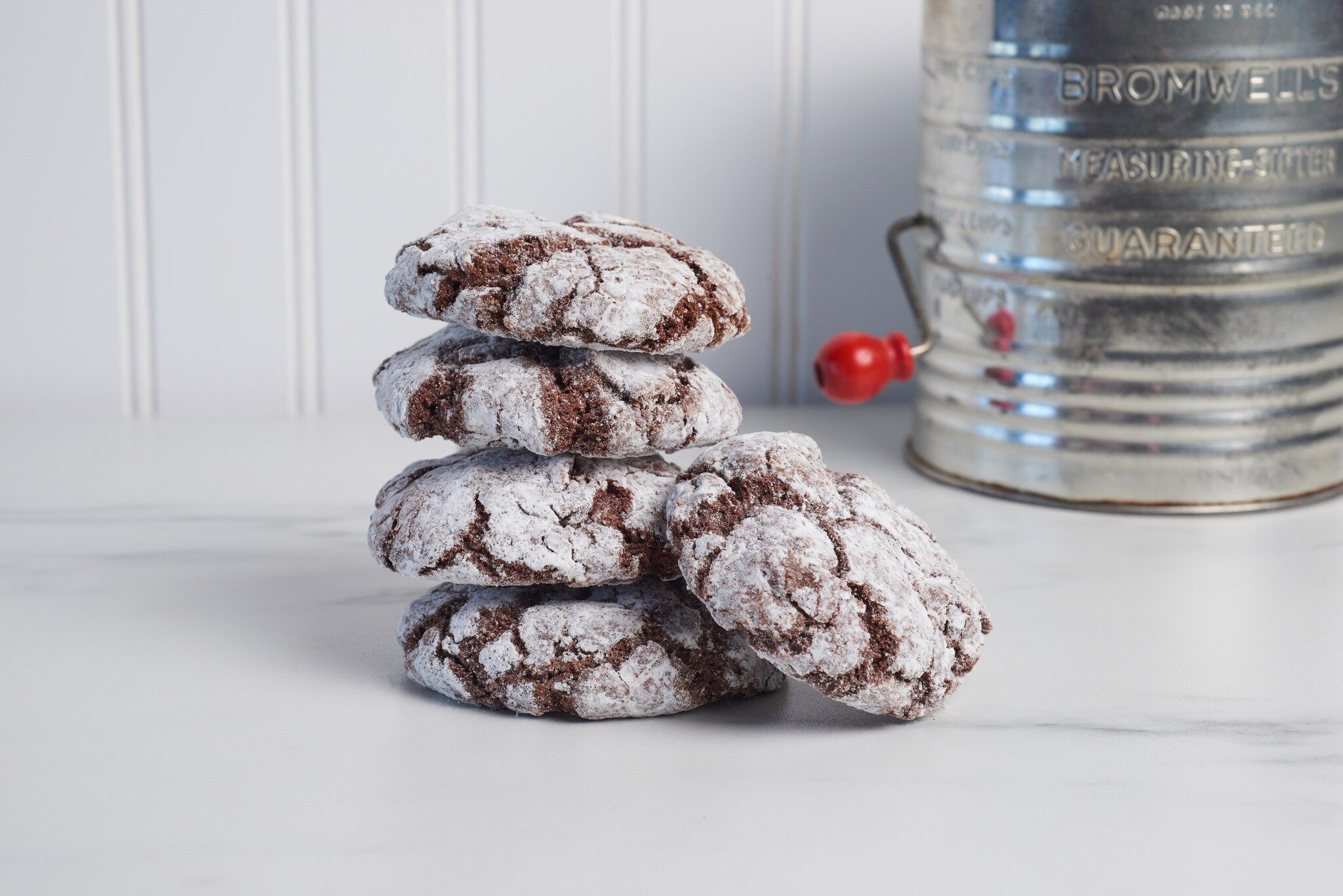 Love this shot of Janet's Cookie's 🍪 chocolate crinkles from our recent photo shoot. 
 
Such a classic cookie and it styled perfectly with this vintage flour sifter.  Brings me back to my childhood days and coming home from school to fresh cookies. 