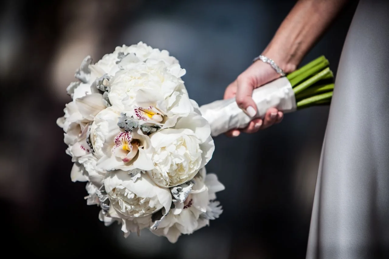 Kate carried a bouquet of white flowers: white peonies, white cymbidium orchid and accented with dusty miller and wrapped with ivory satin ribbon. Matching her simple and elegant dress. 