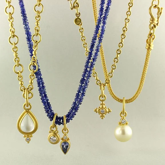 Necklaces of handmade chains and sapphire beads with pendants of aquamarine, diamonds, sapphire and pearl