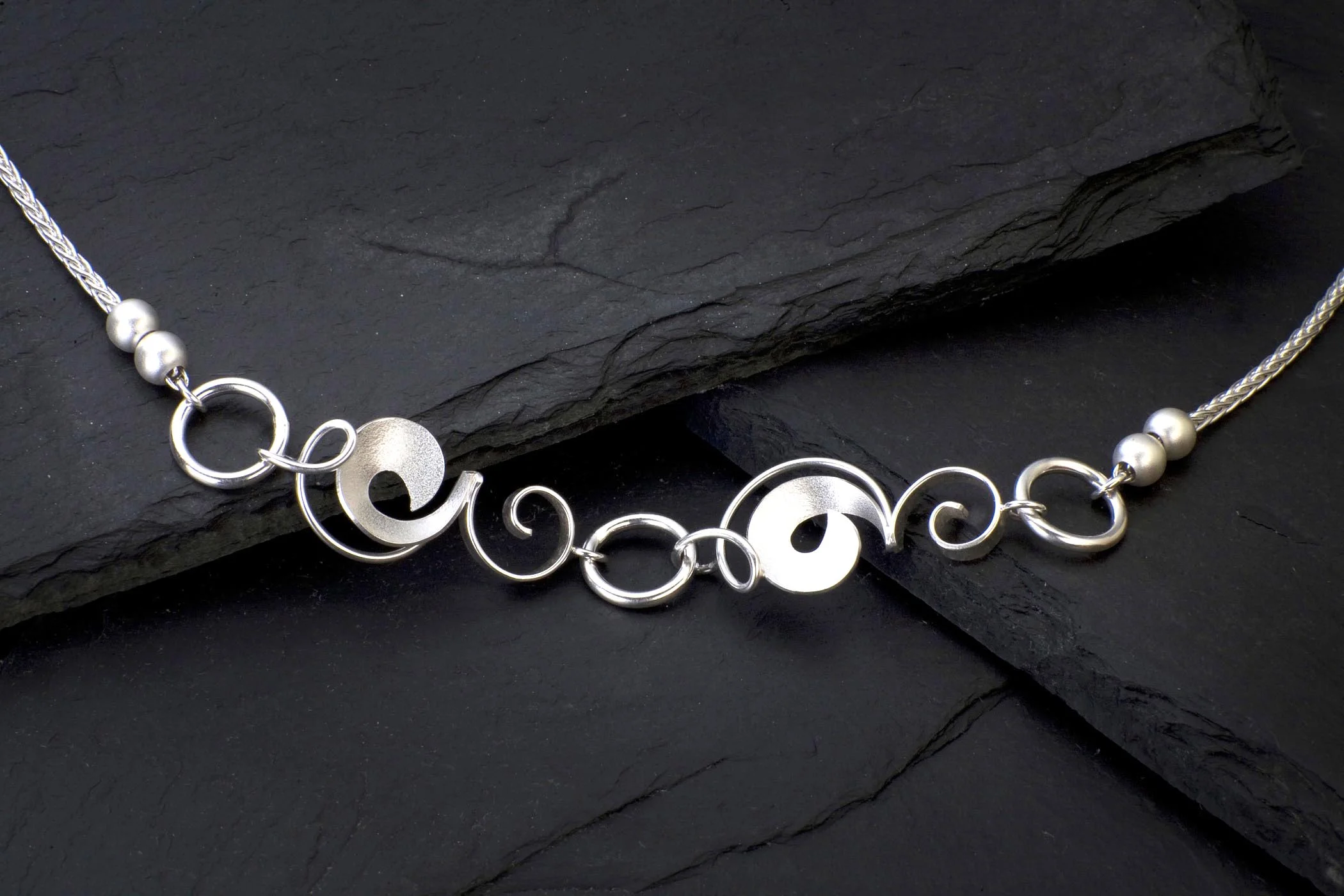 Sterling silver necklace "Pea Vines and Circles" with two fresh water pearls on each side.
