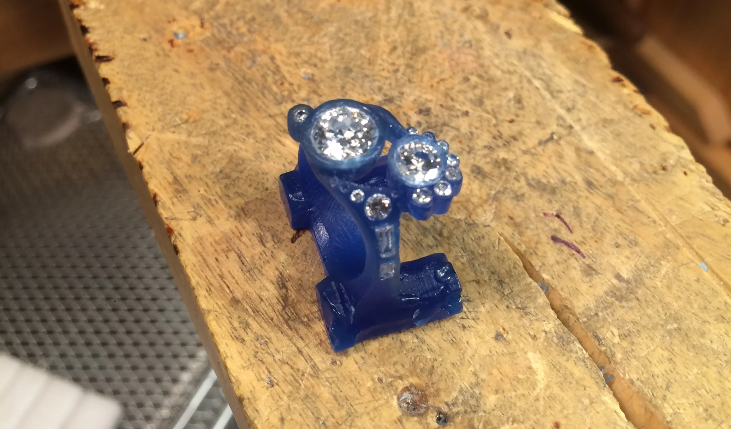 Refining the shape and adding in the smaller diamonds along the band and around the outside of the center stones.