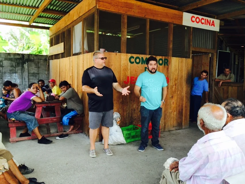 Pastor Donny Kyker of Odessa, and Javier Mendoza of Connect Global speaking to the guests of Comedor de JesuCristo in La Ceiba.