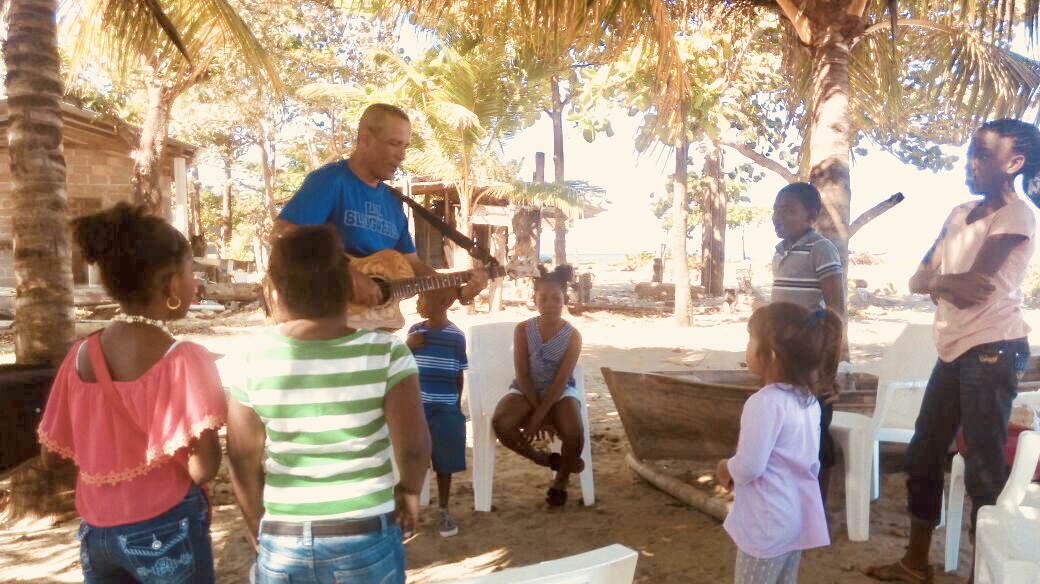 Pastor Nahun Flores offering his gift of worship and his love for one another to children in Trujillo Honduras.