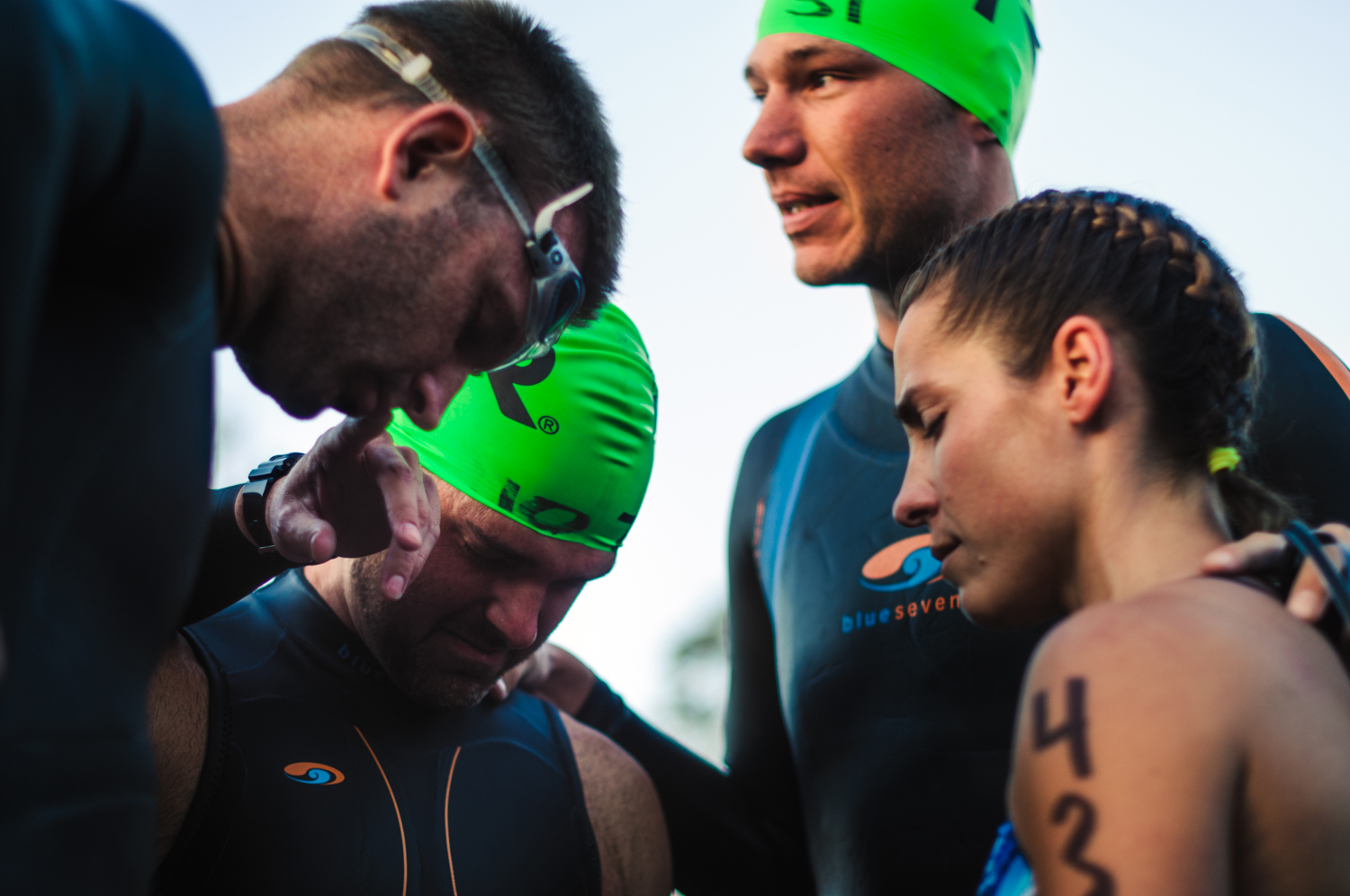  Jason's training partner Zack Mitchell (top right) led his friends in a prayer before entering the water. 