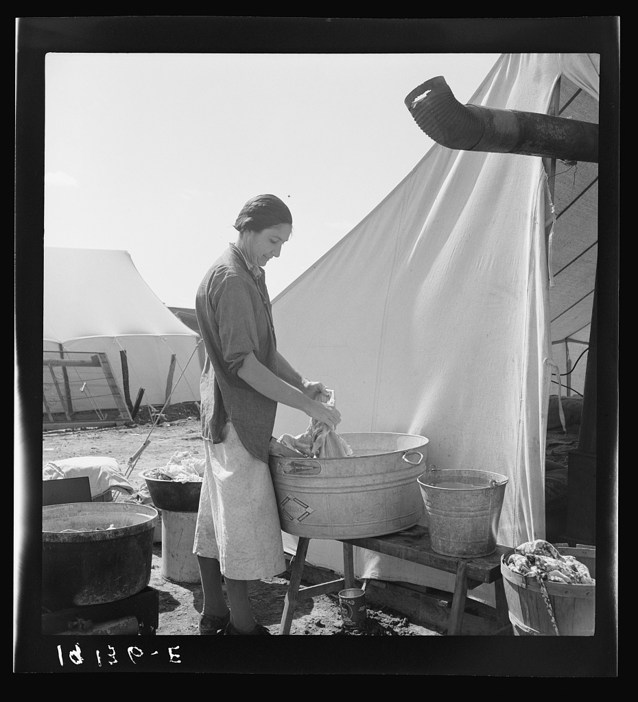  Pea picker camp. This family had been farm owners in Oklahoma, lost their farm and for the last three years "have been draggin' our children around California. We're a have-to case." Calipatria, Imperial Valley, California. 