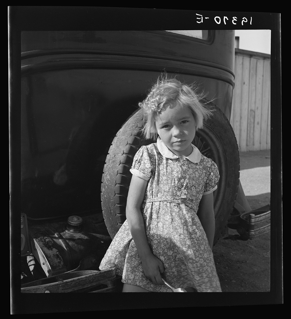  Arkansas girl in migrant camp near Greenfield, Salinas Valley, California. This is an Arkansawyers auto camp, filled almost completely with Arkansawyers recently in California. Rent ten dollars per month for one room, iron bed, electric light. (This