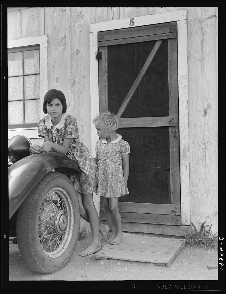  Greenfield, Salinas Valley, California. An Arkansawyers auto camp filled almost completely with migrants from Arkansas. Rent ten dollars a month for one room, iron bed, electricity. Rough board walls with cracks. This community is subject of a study