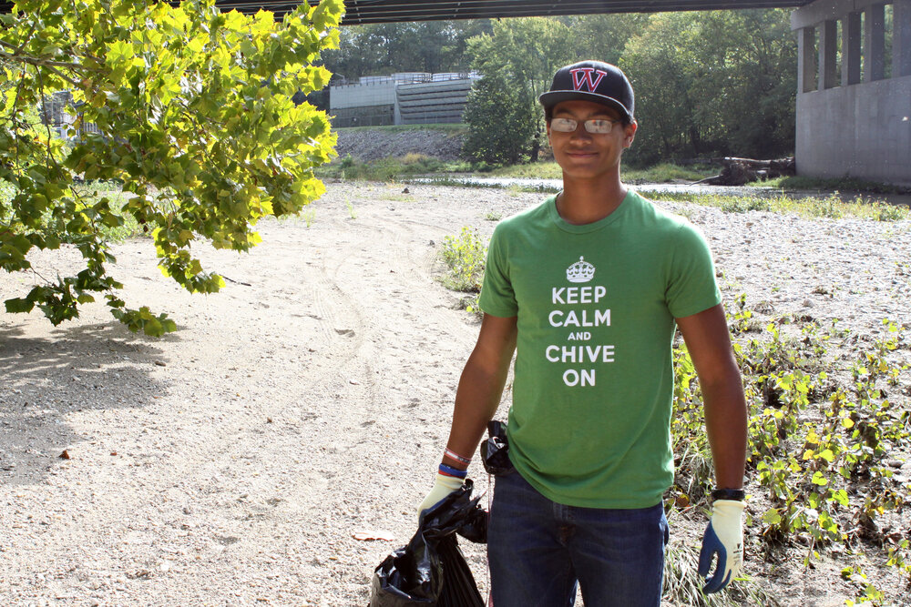 Jacob Caddick '15 cleans up the banks of Sugar Creek