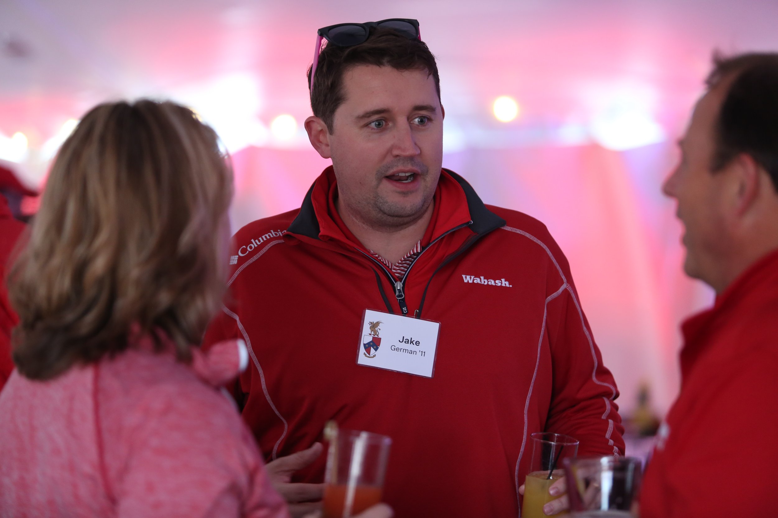  Jake German '11 chats with Scott Feller and Wendy Feller inside the tailgate tent. 