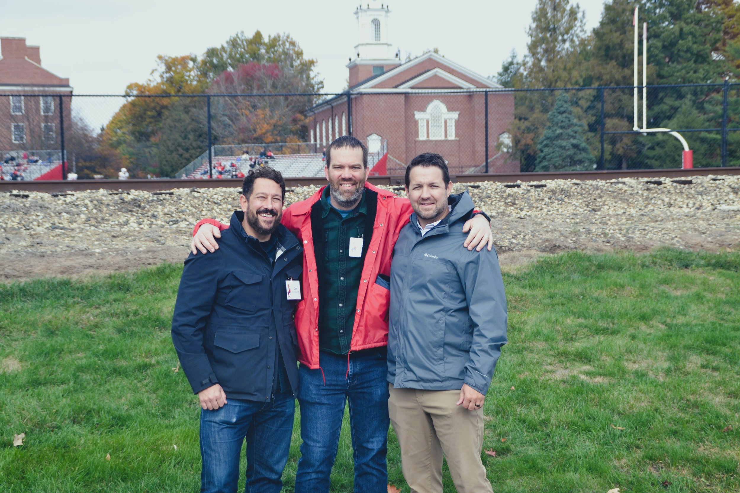  Cameron Starnes '04, Caleb Selby '04, and Bubba Stultz '04 take a group photo just outside the tailgate tent. 