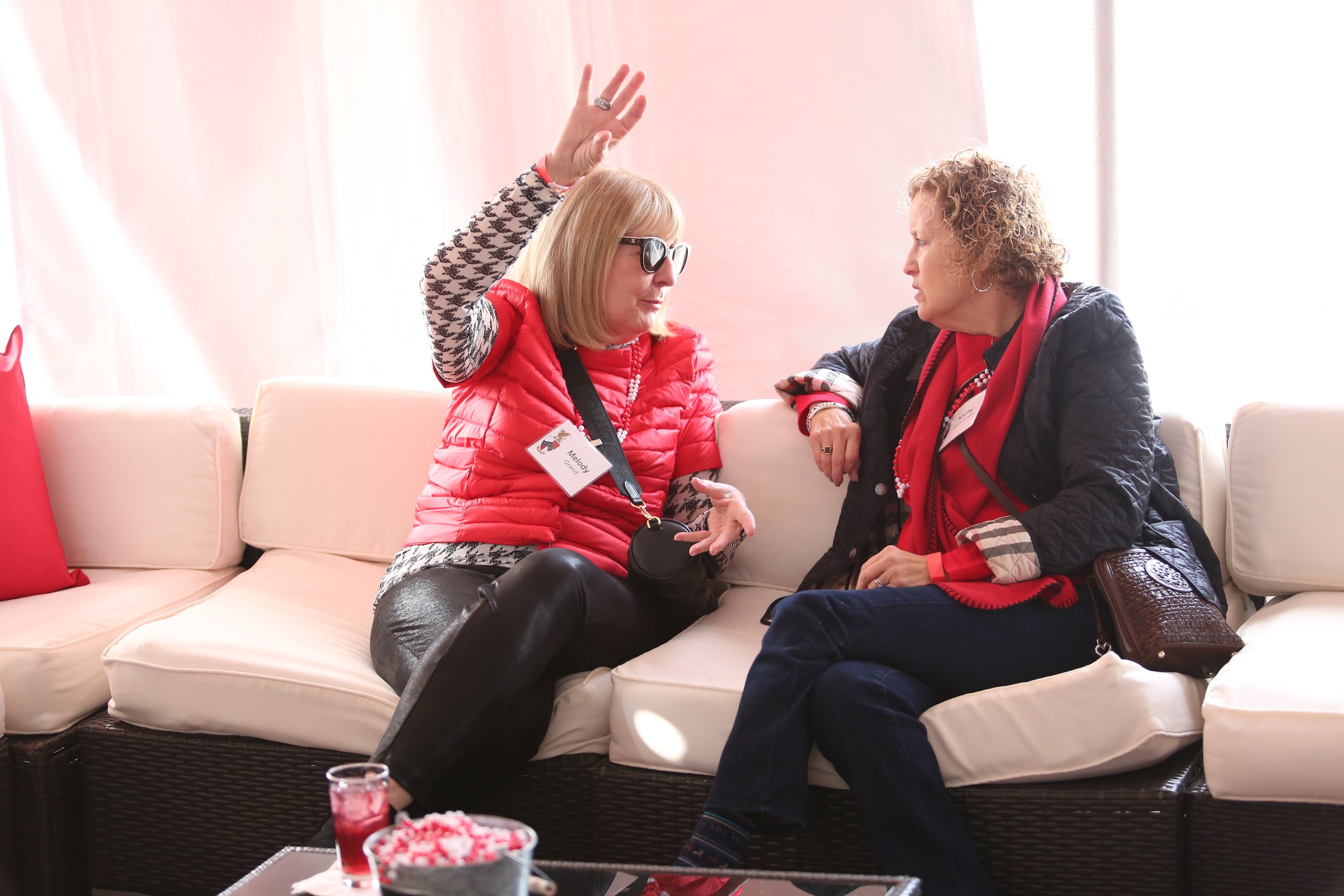  Melody Grand and Kathy Huncilman catch up inside the tailgate tent. 