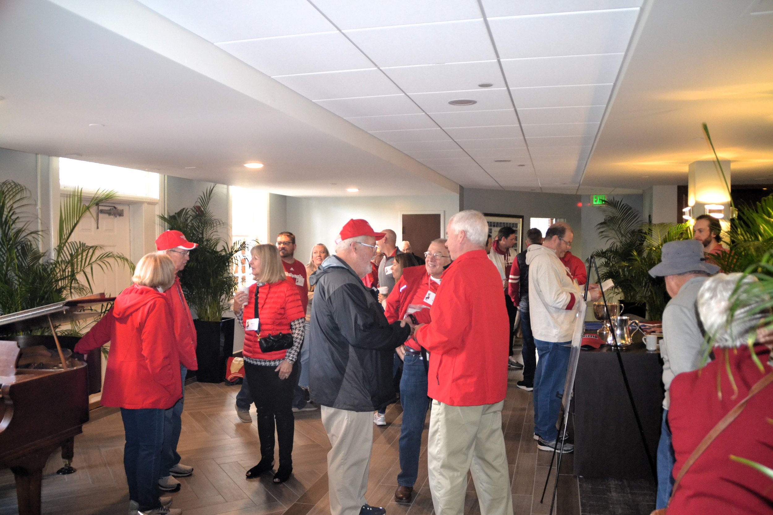  Tau chapter alumni crowd the first floor of the chapter house on Saturday morning. 