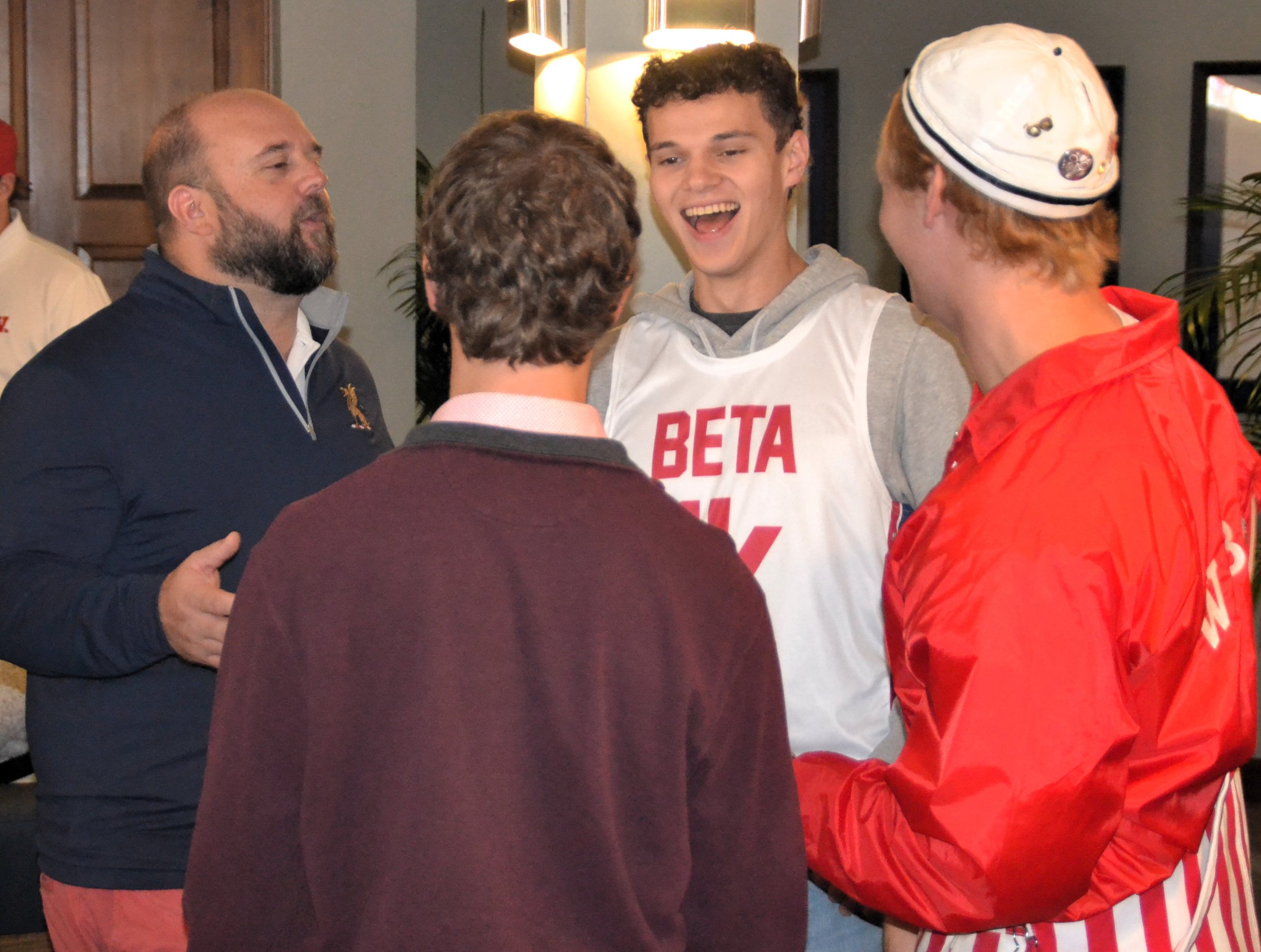  Adam Collins '02 chats with Lucas Carpenter '26, Luka DiFilippo '25, and Preston Art '26 at the chapter house. 