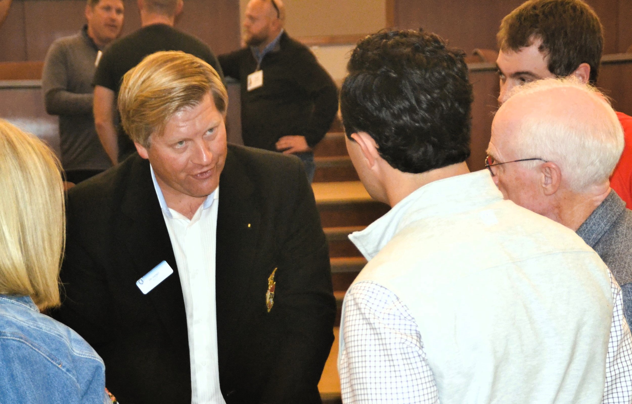  Zac Haines Miami '05 shows historic fraternity pins to gathered alumni following the history presentation. 