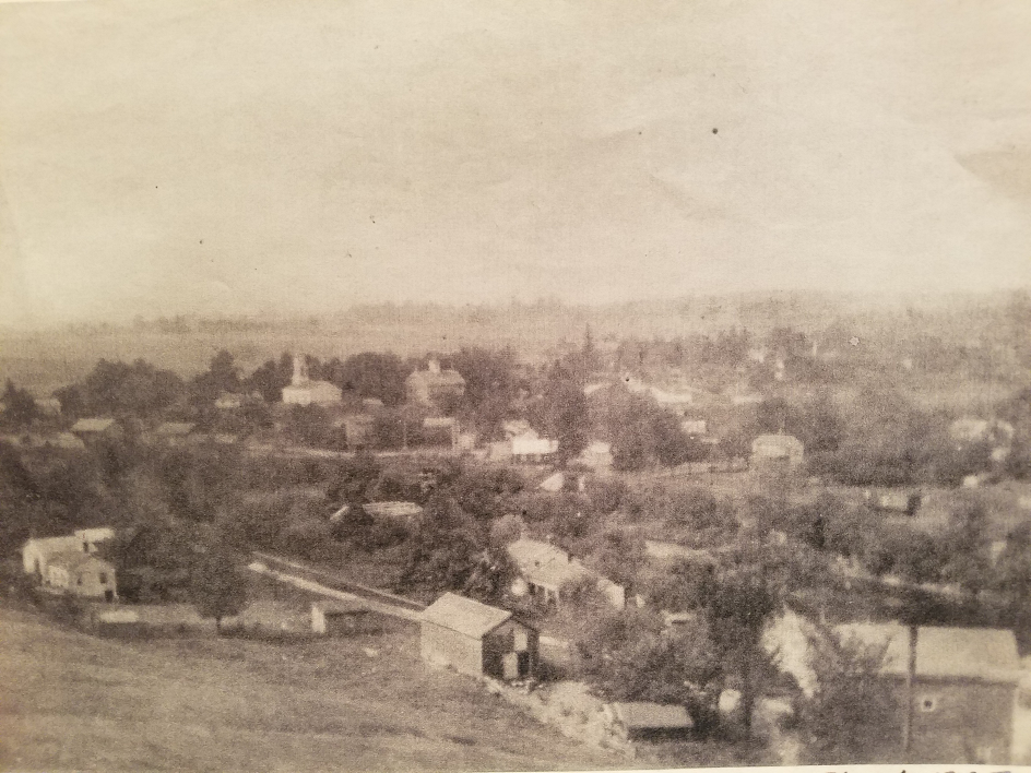 The village of Orleans, circa 1895. The school is seen in the center of the photo, immediately to the right of the white church.