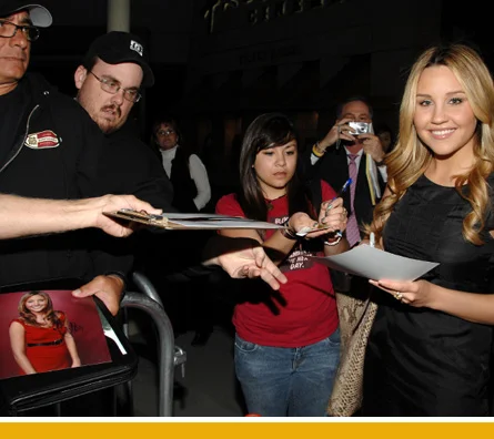 Amanda signs autographs for fans she hasn't mowed down yet.
