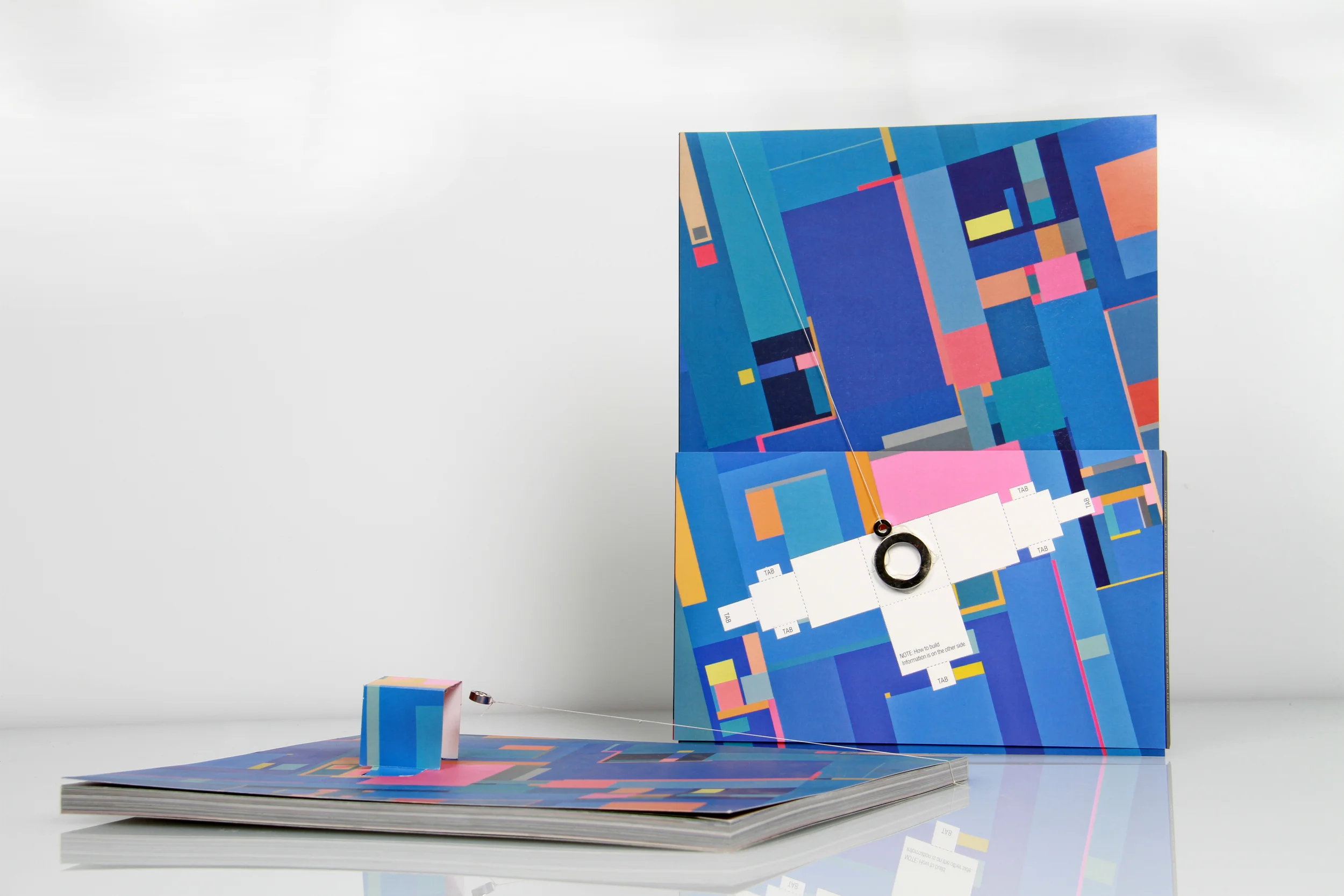 Each copy of Carrier Pigeon Vol. II issue 3 includes a unique cover design that contains components for a DIY, magnetic, paper sculpture by Adam Lister. Instructions for assembly are included on the belly band.