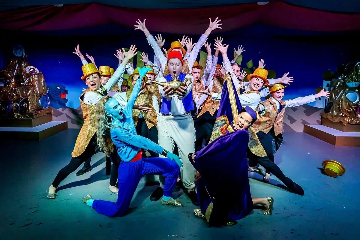 A cast photo of a homeschool theatre production of Disney's Aladdin.