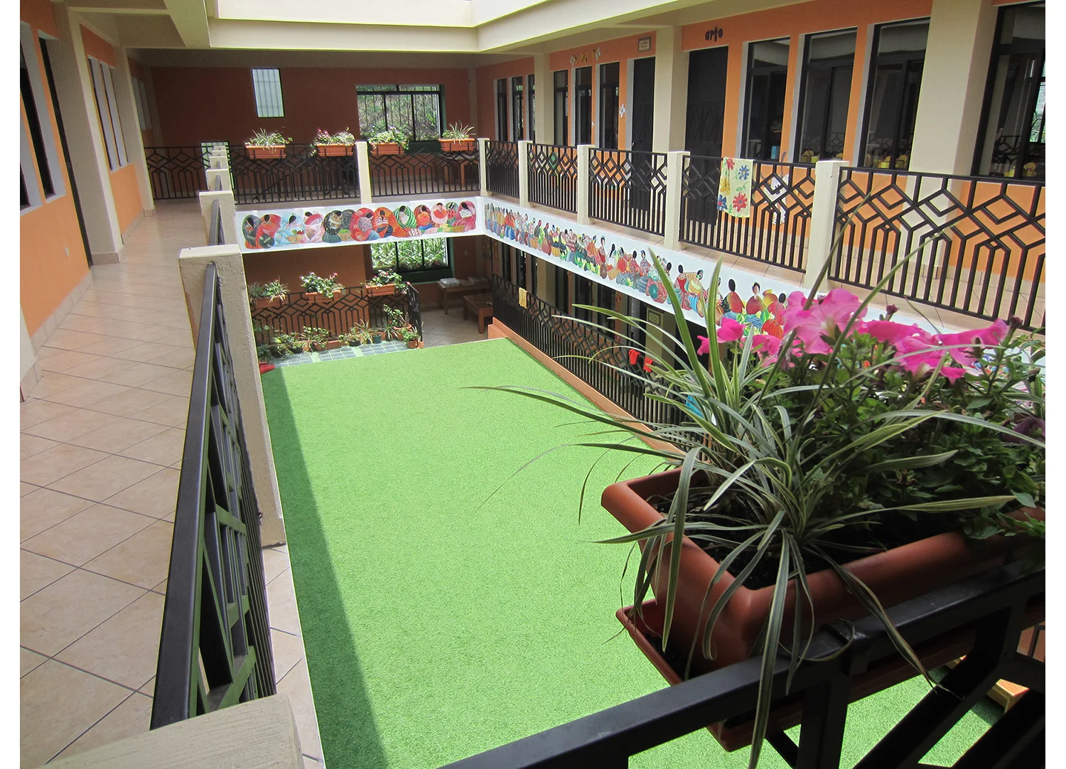  An interior courtyard surfaced with turf provides a safe outdoor learning and playing space for students. &nbsp; 