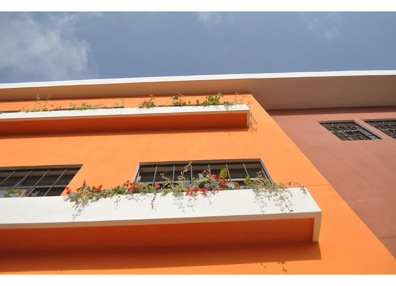  The exterior is colorful and whimsical to signify that this is a building dedicated to children. Decorative trim on the exterior was inspired by local weaving patterns, and colors were selected with community input. &nbsp;Window box gardens are a li