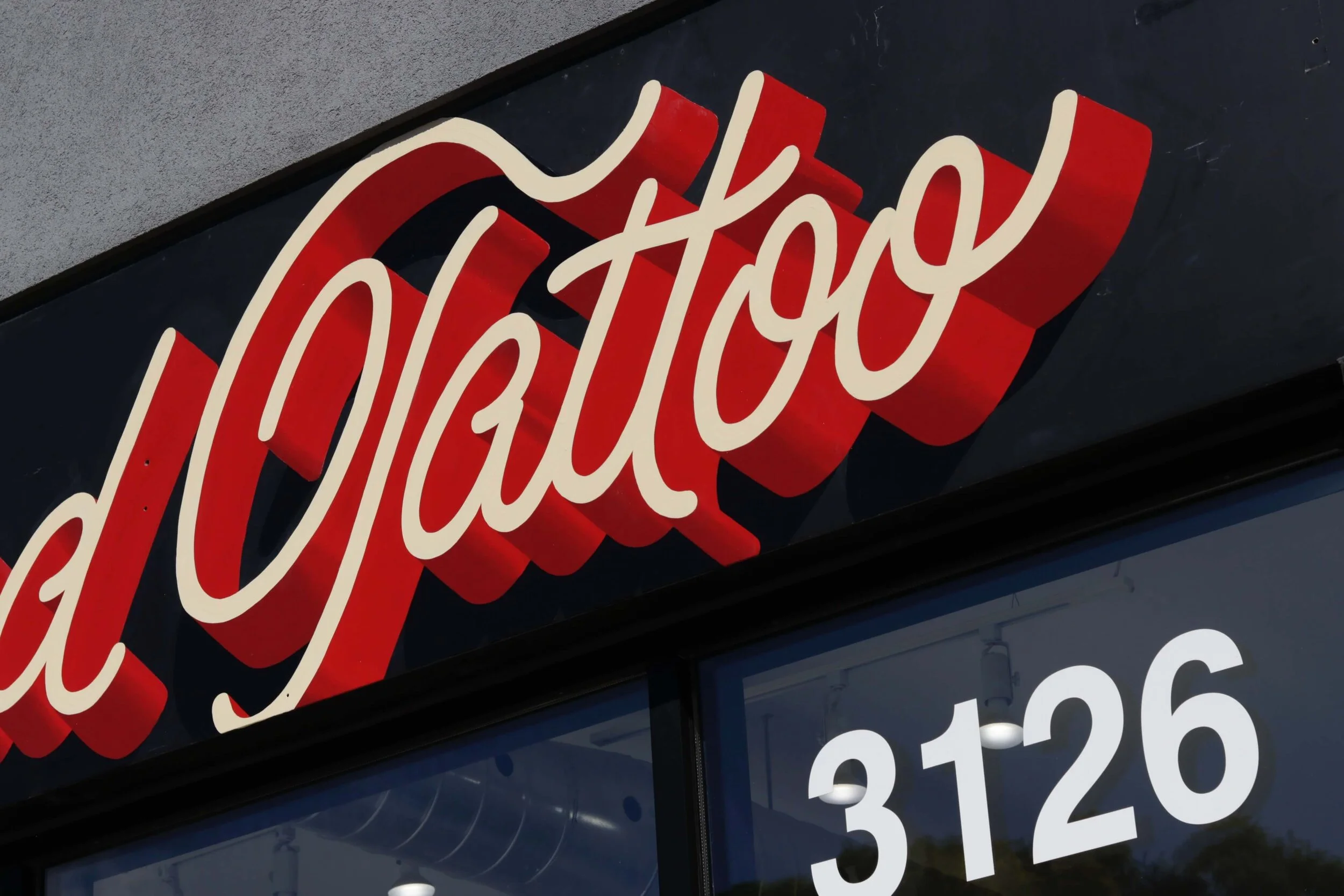  Close up of finished handpainted store sign at GlassBird Tattoo in Toronto  