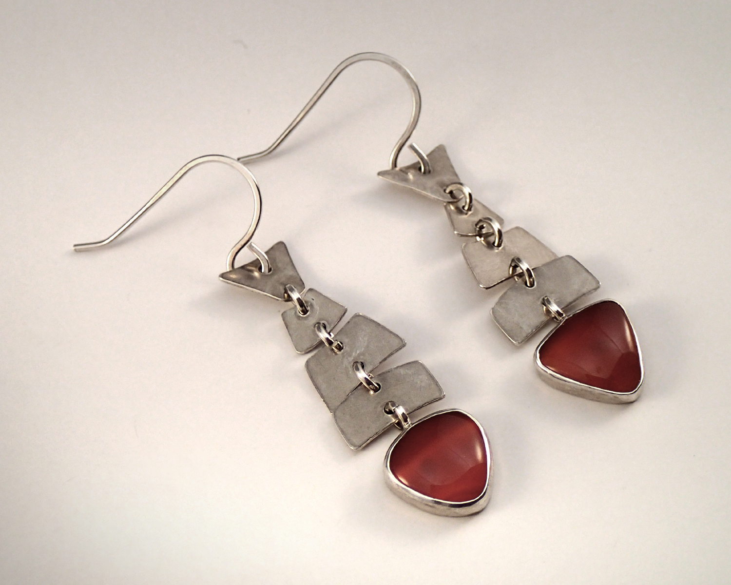 Articulated fish earrings with carnelian