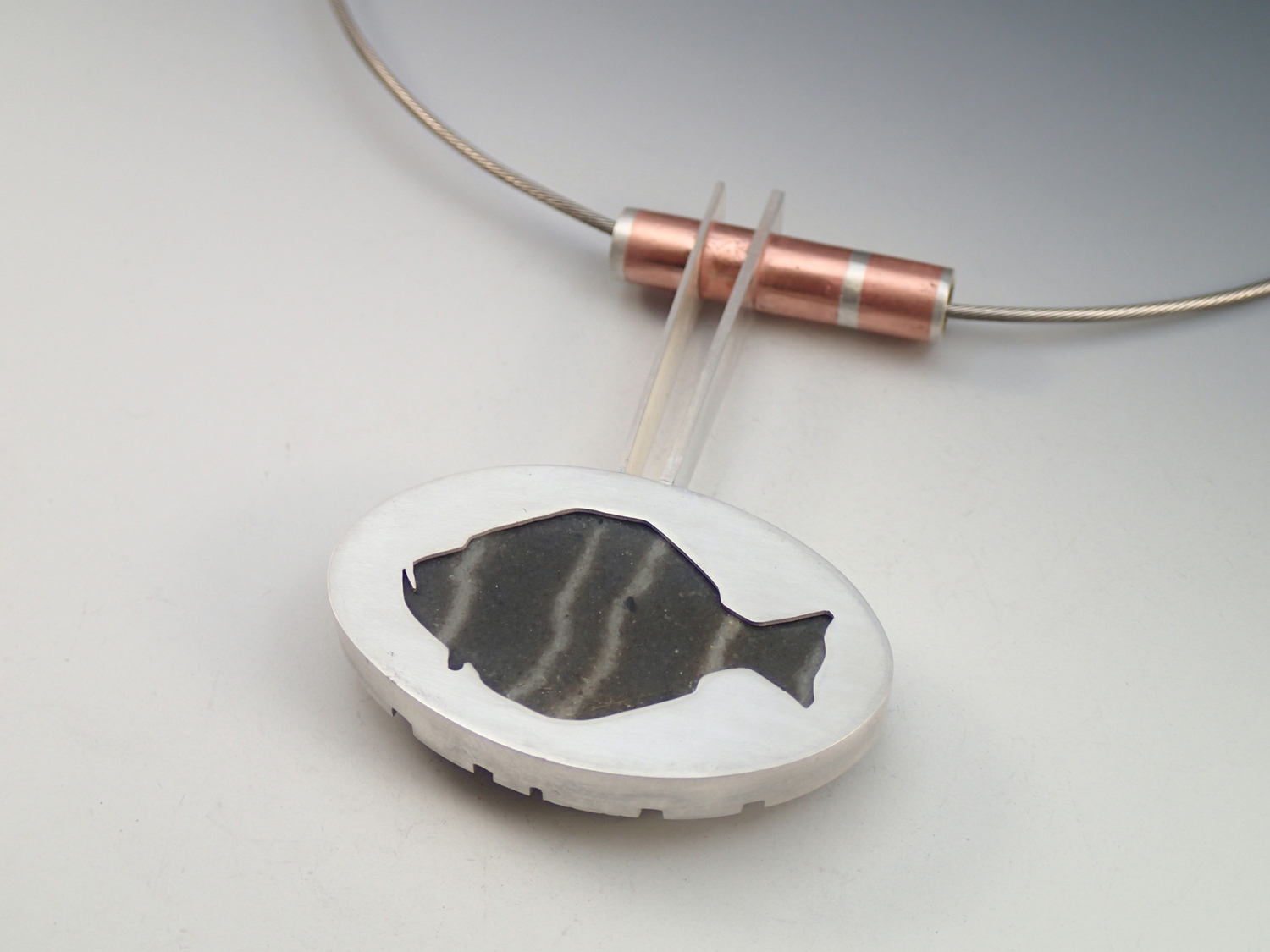 The reverse of the Memory Stone necklace has a halibut cut out of the bezel, exposing the back side of the stone. This is one of the overfished species of Newfoundland, and we found the carcass of an illegally caught halibut on that same beach.