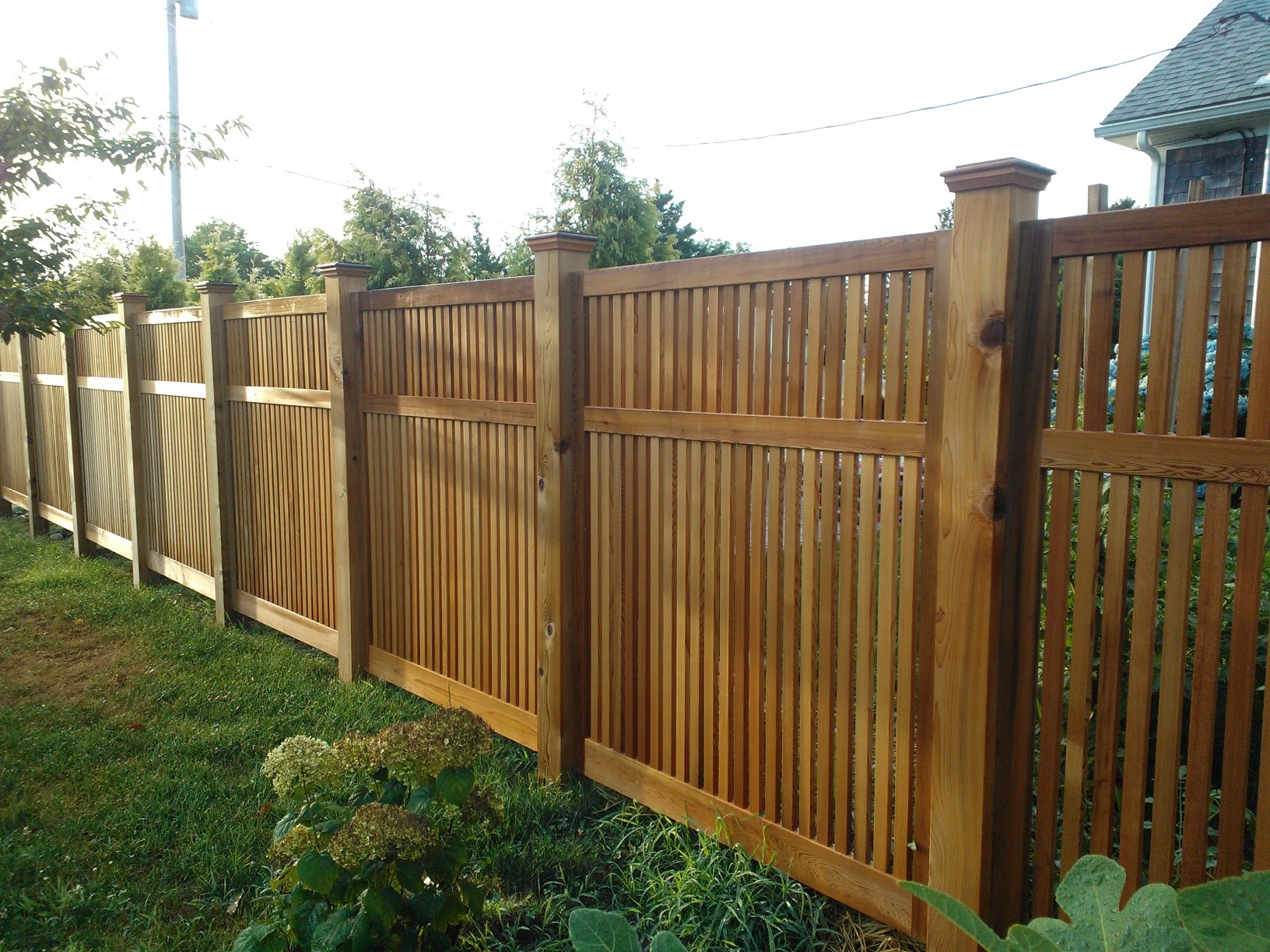  This 100ft fence is constructed from Western Red Cedar in 5'x6' panels, between 6"x6" red cedar posts. One of the unique features of our fence panels is that both sides are identical, so you and your neighbor can enjoy the design as it was intended.