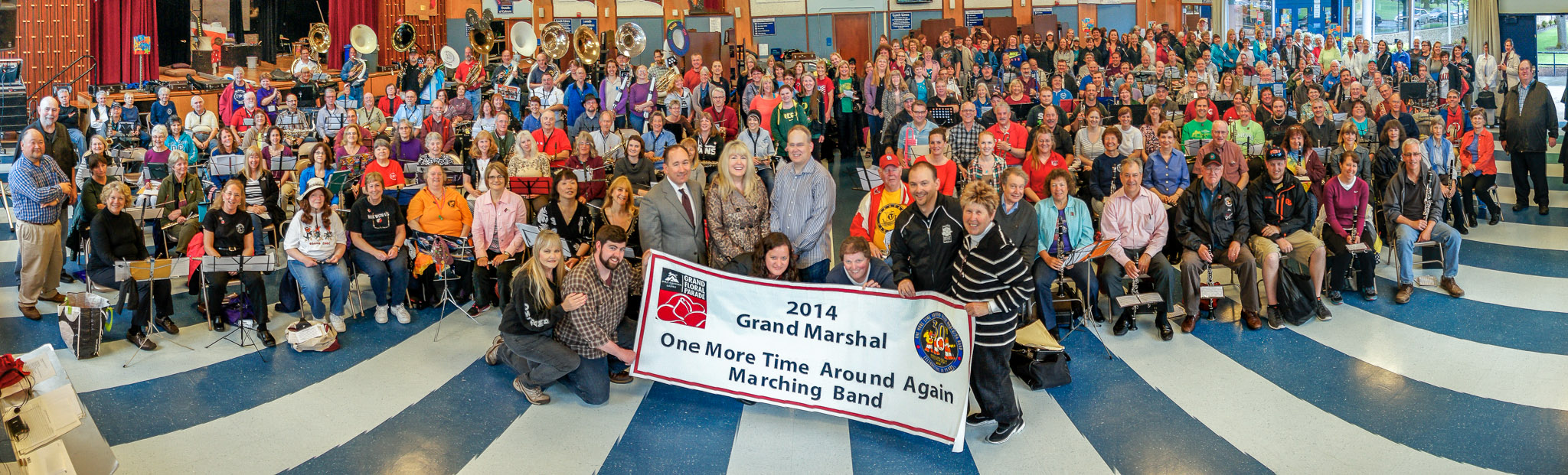 Rehearsal posing with the Grand Marshal banner, Thursday, May 9th, 2014.