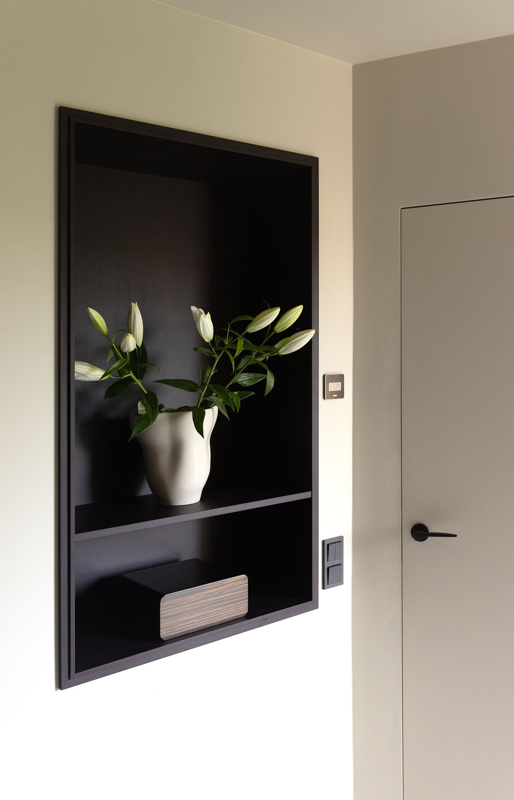Minimalistic door and bespoke shelf in aubergine stained wood