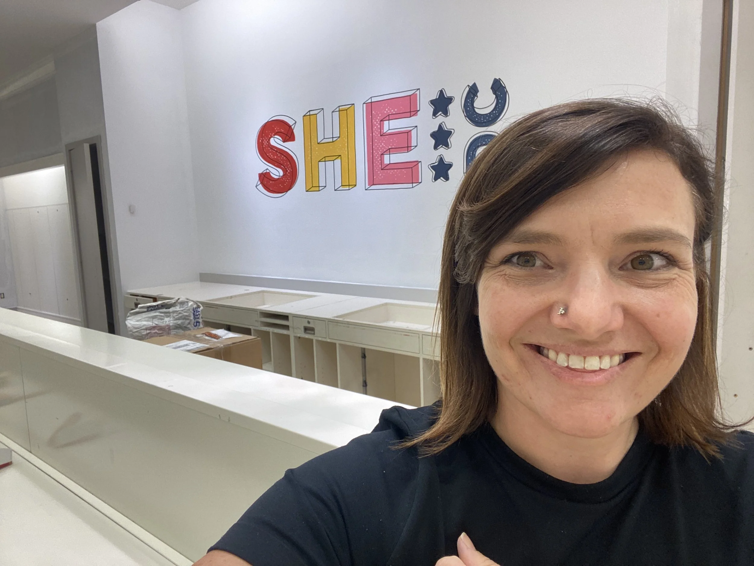 I hand painted the SHE DC logo on the wall behind the bar for the opening. 