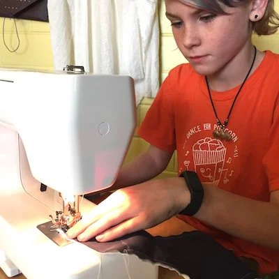 A student using a sewing machine.